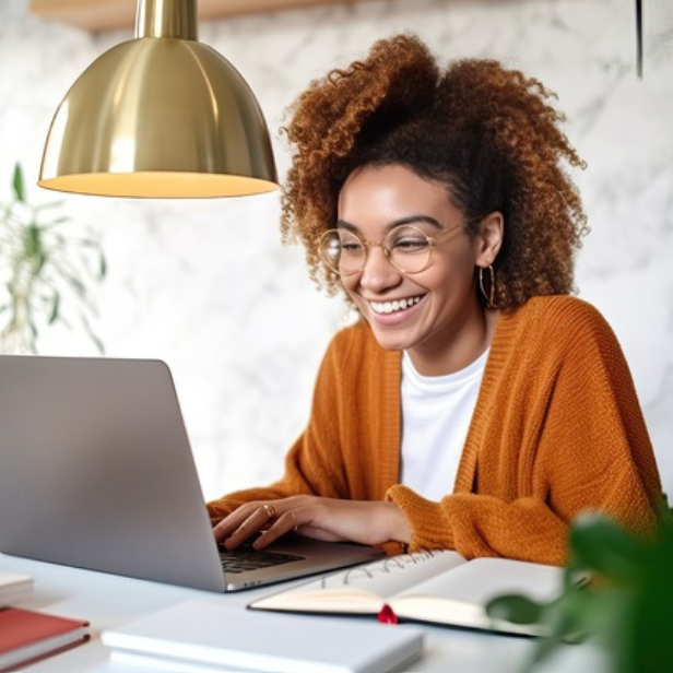 student smiling at laptop